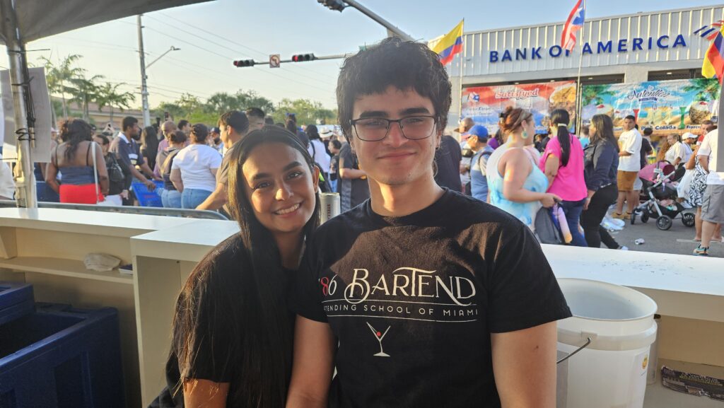 Two 786-Bartend classmates smiling together at Calle Ocho 2025, celebrating their first major bartending event