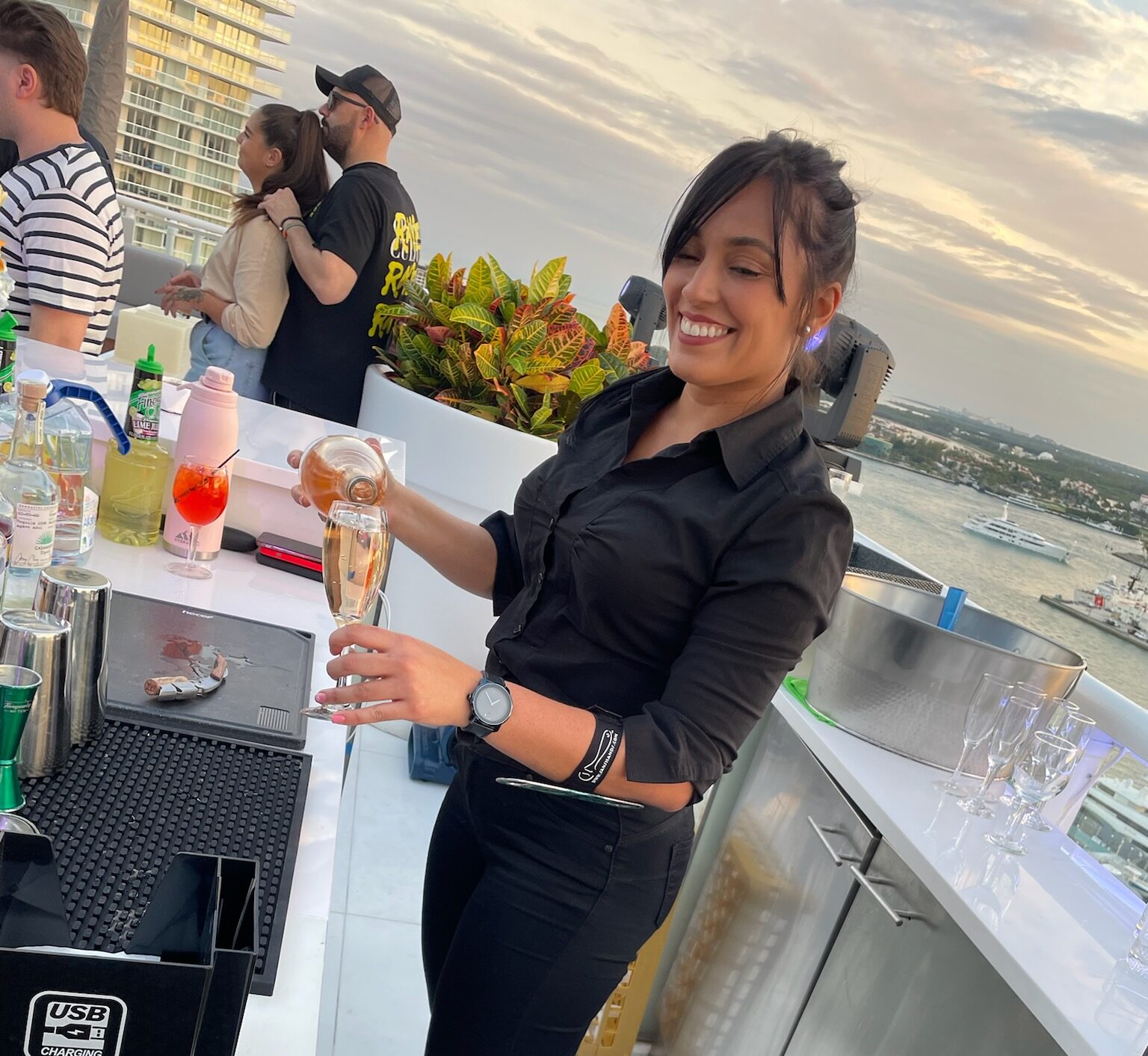 Lisany, one of our graduates. Bartending a private rooftop party for Ultra music conference.