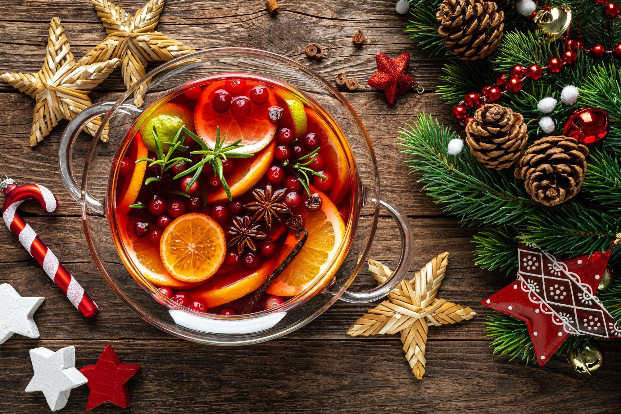 Christmas punch. Festive red hot toddy cocktail, drink with cranberries and citrus fruits