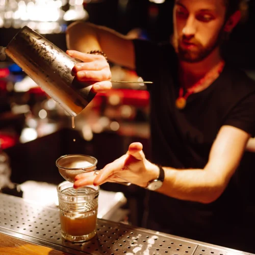 Bartender preparing cocktails behind a bar in Florida