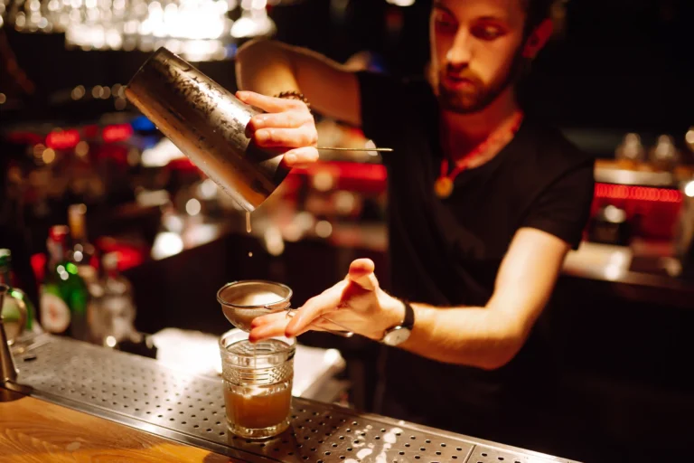 Bartender preparing cocktails behind a bar in Florida